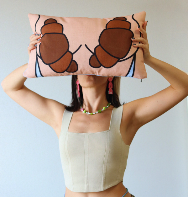 Antria Petrou holding a BRUNCHING croissant pillow